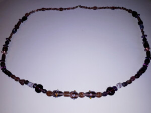 Artikel- Nr. 6HK , Preis 19,25 EUR . Perlenhalskette, violett, 3 grosse Perlen im vorderen Bereich mit Verzierungen . Glasperlen aufgereiht auf Nylonseil , ohne Verschluss . Enden sind geknotet , muss auch so bleiben , sonst Prost Mahlzeit ! Gesamtlänge c